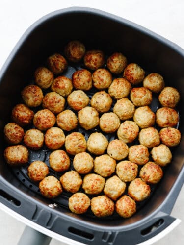 Air fryer frozen meatballs are easy and delicious and taste as fresh as if you made them from scratch! Try these out if you are in need of a quick delightful meal... your family will love them! Frozen meatballs in an air fryer basket.