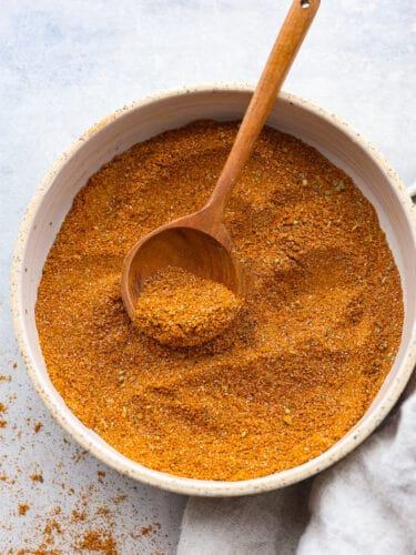 Shawarma seasoning brings aromatic and authentic Middle Eastern flavors to your recipes. This easy to assemble spice blend is great to make ahead and have on hand when you want to elevate your cooking flavors. A bowl of mixed spices with a wooden spoon.