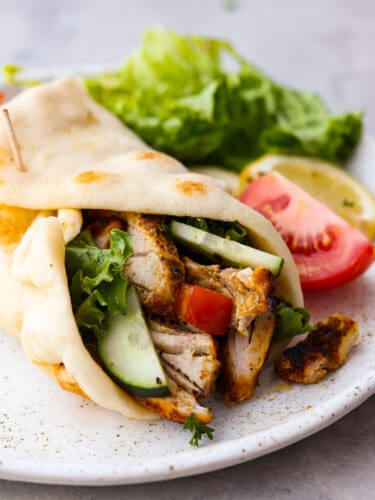 This Middle Eastern chicken shawarma is packed full of flavorful chicken that is seasoned with a delightful array of spices. It makes a great lunch or dinner that everyone will go crazy for! Chicken shawarma wrapped in a pita with some vegetables.