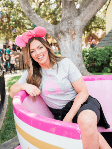 To celebrate the blog's 10th anniversary, our team went to the Happiest Place on Earth! These are a few must-try foods for your next trip to Disneyland! A woman sitting in a pink Disneyland teacup.