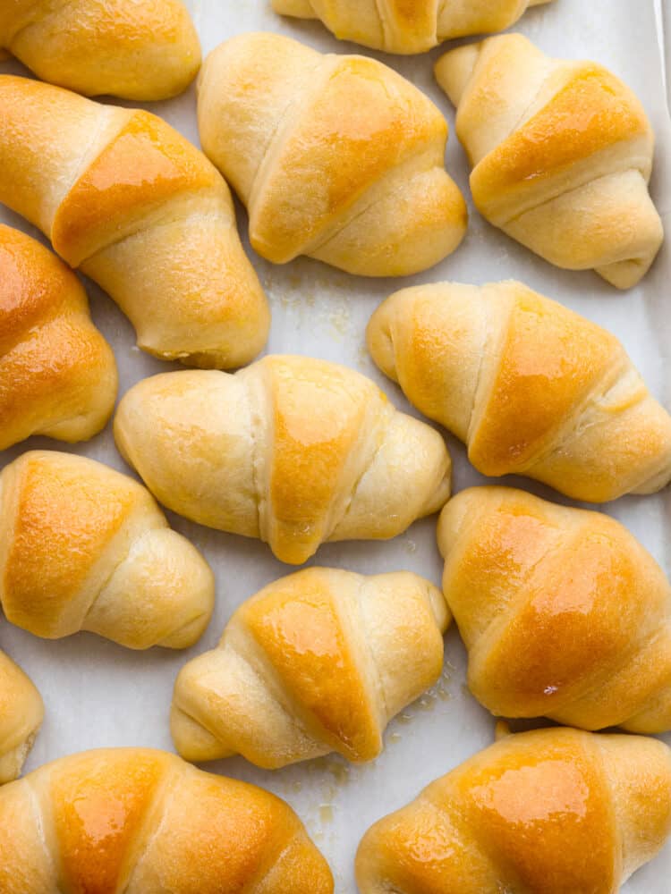 If you are looking for the perfect roll that goes with every single meal, then you've found it! These homemade crescent rolls are soft, golden brown, and have a delicious and buttery taste. Homemade crescent rolls cooked on a baking sheet with parchment paper.